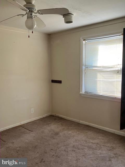 unfurnished room with ceiling fan and light carpet