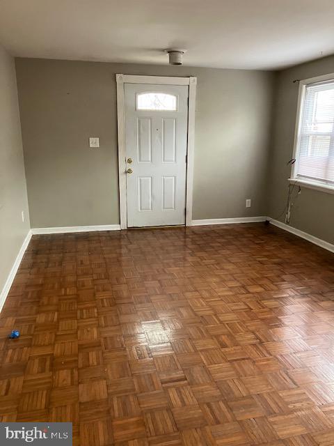 entrance foyer featuring dark parquet flooring