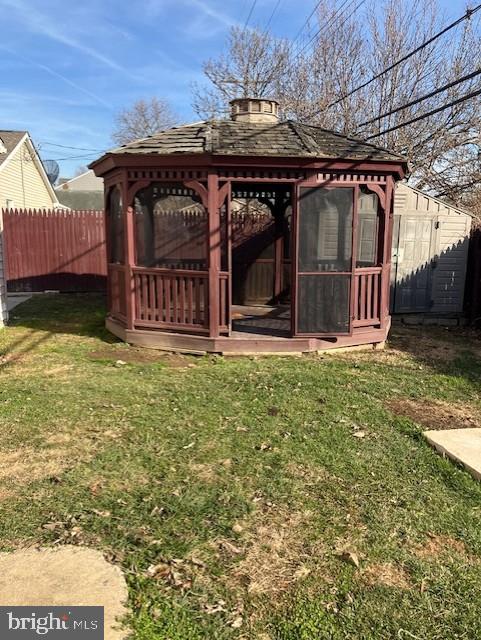 exterior space featuring a lawn and a gazebo