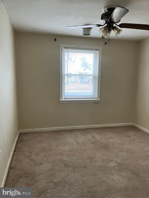 spare room featuring carpet floors and ceiling fan