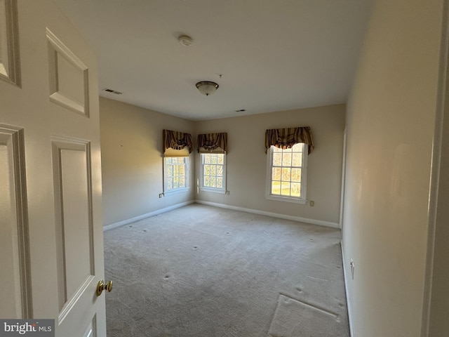 unfurnished room with light colored carpet