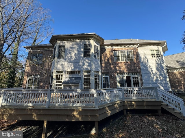 rear view of property featuring a deck