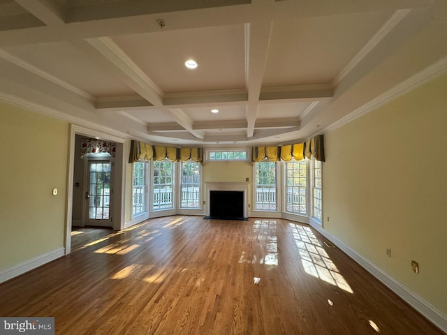 unfurnished living room with beamed ceiling, wood-type flooring, coffered ceiling, and ornamental molding