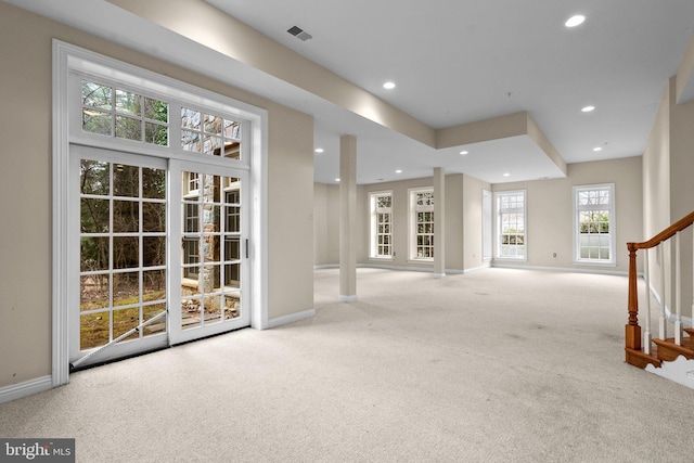 unfurnished living room featuring light colored carpet