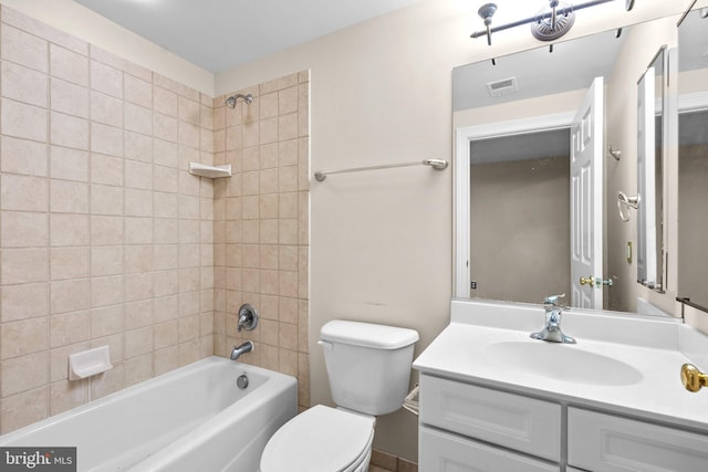 full bathroom with tiled shower / bath combo, vanity, and toilet