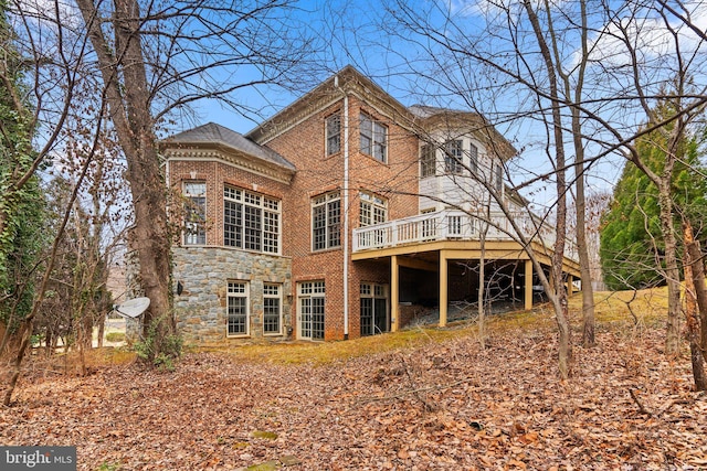 rear view of house with a wooden deck