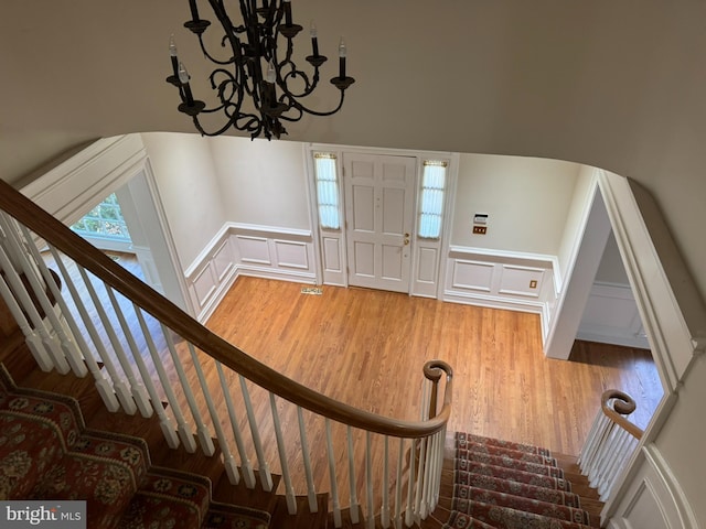 entryway featuring hardwood / wood-style floors and a notable chandelier