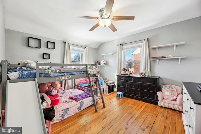 bedroom featuring light hardwood / wood-style flooring, ceiling fan, and lofted ceiling