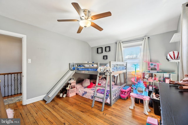 bedroom with ceiling fan, vaulted ceiling, and light hardwood / wood-style flooring