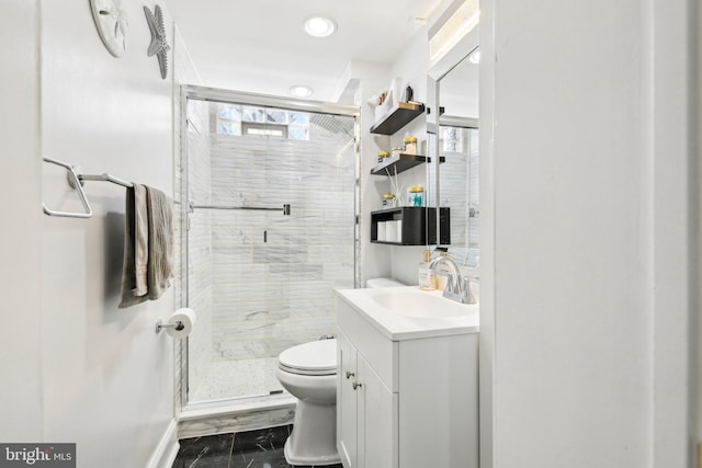 bathroom featuring walk in shower, vanity, and toilet