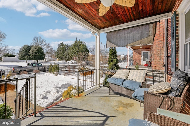 snow covered patio with ceiling fan