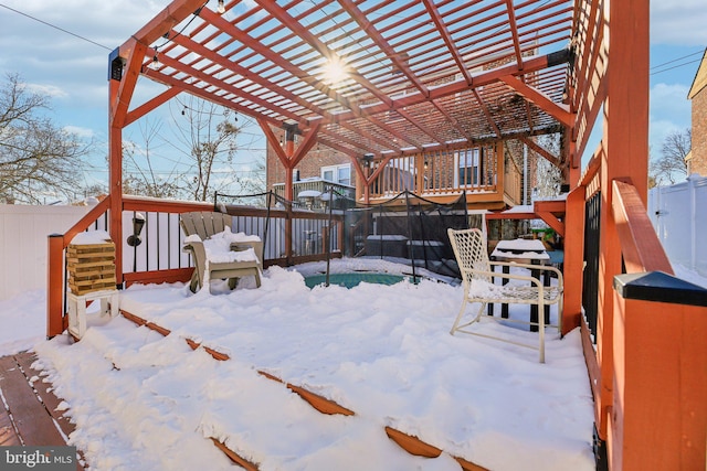 snow covered deck featuring a pergola