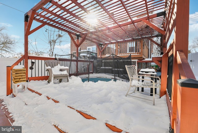 snow covered deck with a pergola