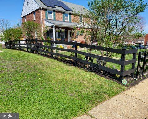 exterior space with a lawn and solar panels