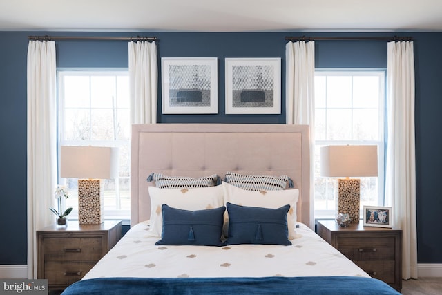 bedroom featuring carpet floors and multiple windows