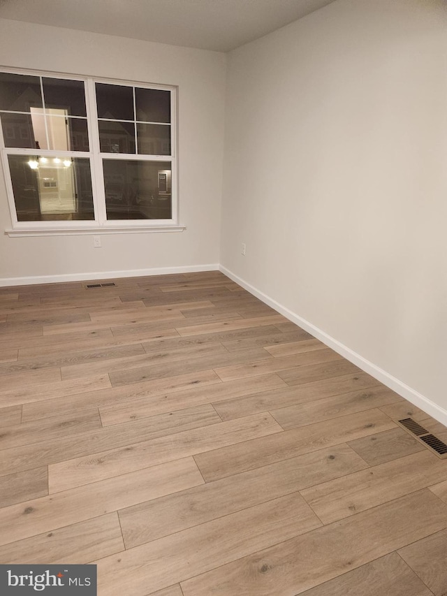 spare room with light hardwood / wood-style flooring