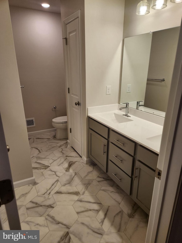 bathroom featuring vanity and toilet