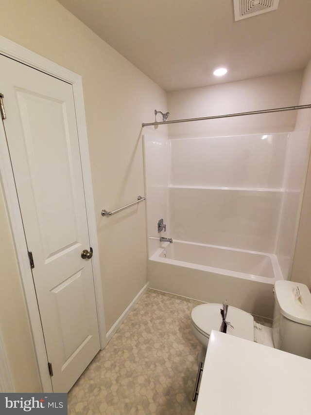 bathroom with toilet and bathing tub / shower combination