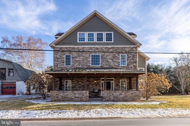 view of front of property featuring a garage and a porch