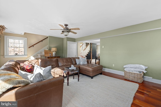 living room with dark hardwood / wood-style flooring and ceiling fan