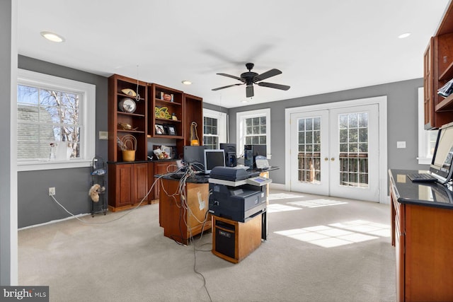 home office with french doors, light colored carpet, and ceiling fan