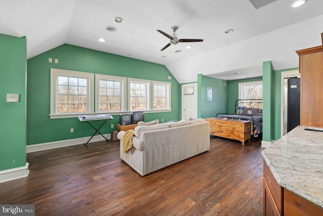 living room featuring dark hardwood / wood-style flooring, vaulted ceiling, and ceiling fan