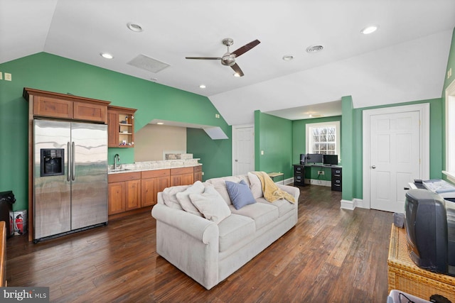 living room with dark wood-type flooring, ceiling fan, lofted ceiling, and sink