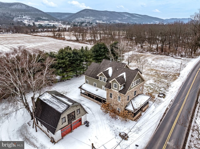 snowy aerial view with a mountain view