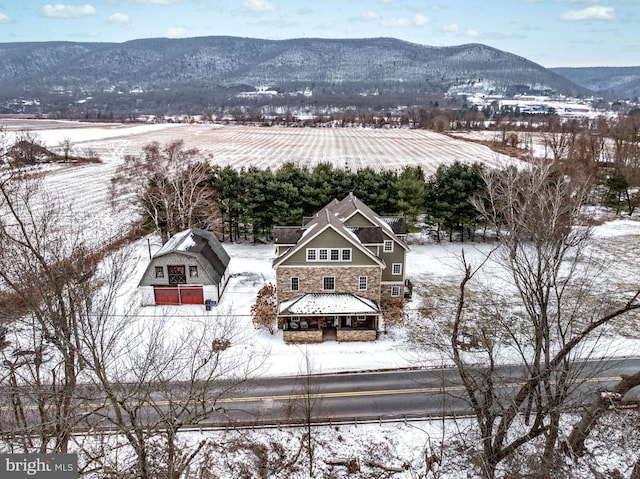 snowy aerial view with a mountain view