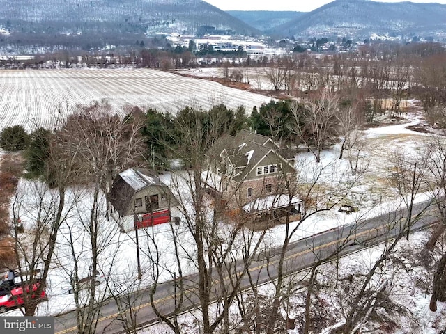 snowy aerial view with a mountain view