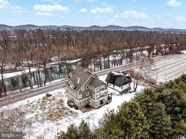 snowy aerial view featuring a mountain view