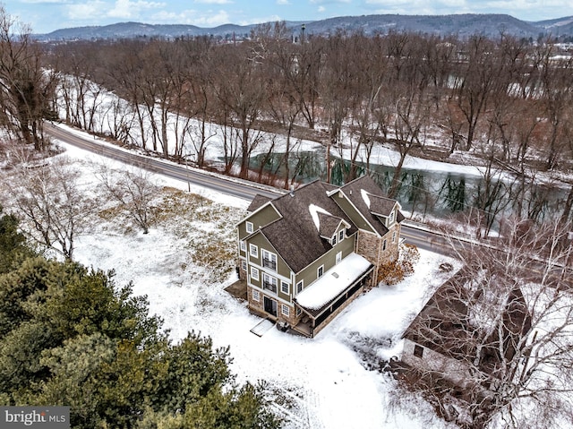 snowy aerial view featuring a mountain view