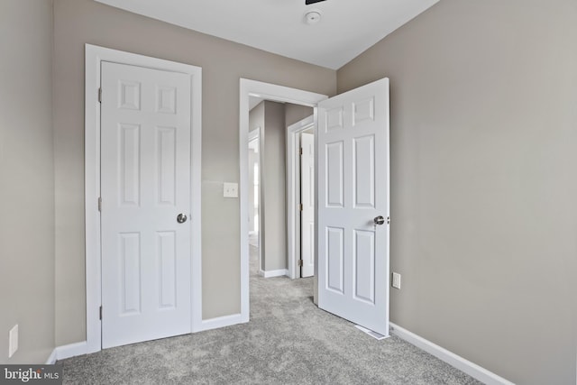 unfurnished bedroom featuring light carpet