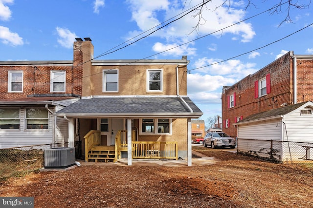 rear view of property featuring cooling unit