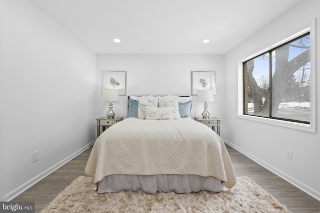 bedroom with dark hardwood / wood-style flooring