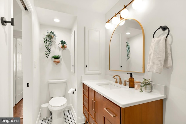 bathroom featuring tile patterned floors, vanity, and toilet