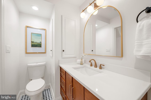 bathroom featuring toilet, tile patterned floors, and vanity