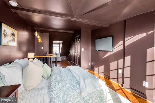 bedroom featuring light wood-type flooring and a closet