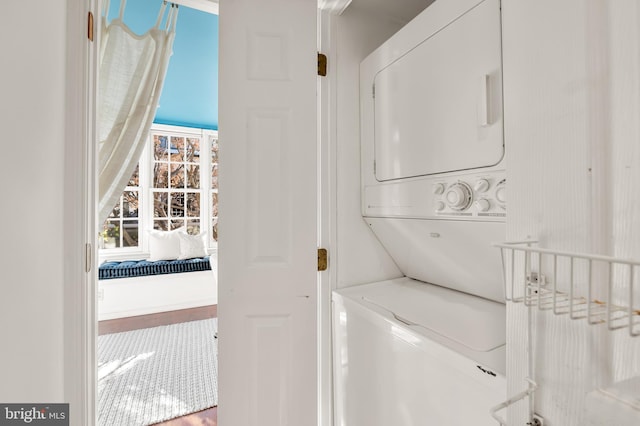 clothes washing area with stacked washer and dryer