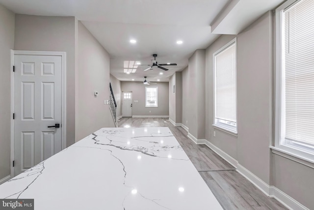 foyer entrance featuring ceiling fan and light hardwood / wood-style flooring