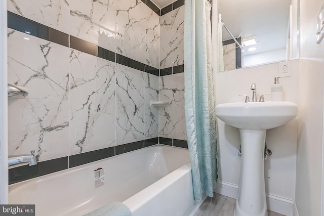 bathroom with wood-type flooring and shower / tub combo