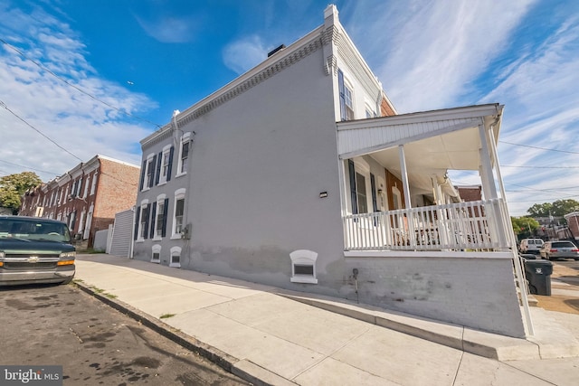 view of property exterior featuring a porch