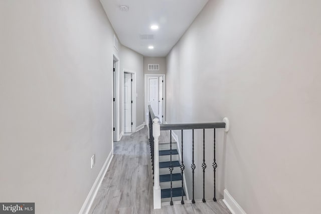 hallway with light hardwood / wood-style floors