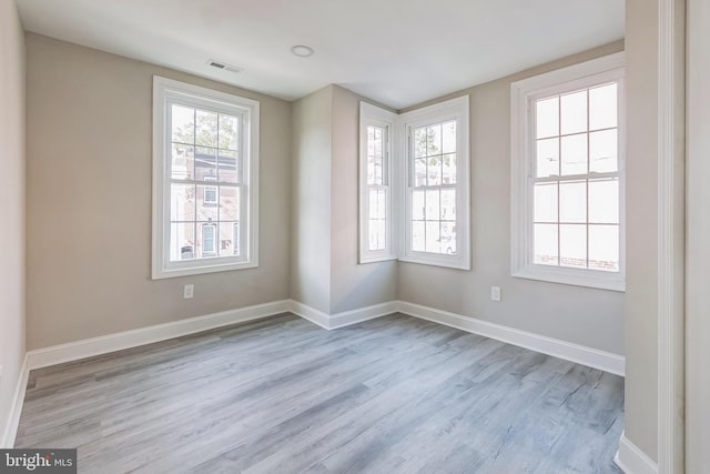 unfurnished room with light wood-type flooring