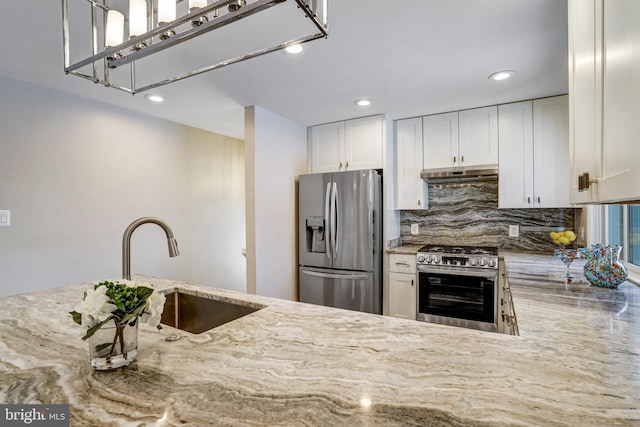 kitchen featuring white cabinetry, sink, light stone counters, and stainless steel appliances