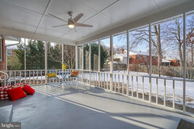 unfurnished sunroom featuring ceiling fan