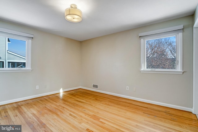 spare room featuring light hardwood / wood-style flooring