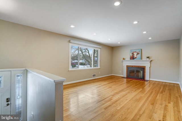 unfurnished living room with light hardwood / wood-style flooring