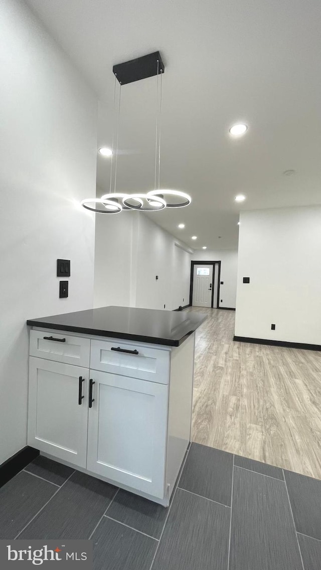 kitchen with white cabinets and hanging light fixtures