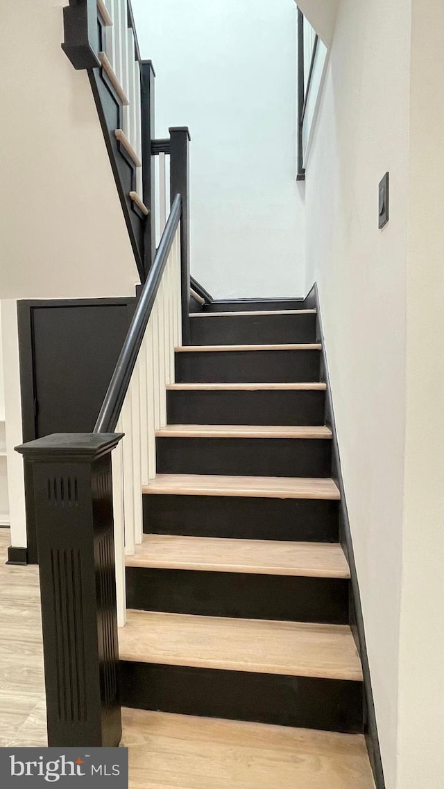 stairway with wood-type flooring